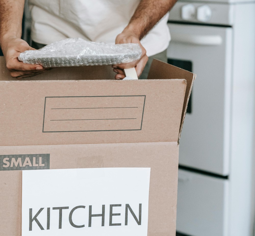 Man Packing Up Plates In The Kitchen